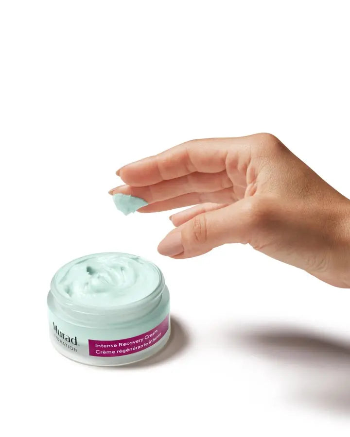 a hand holding some intense recovery cream