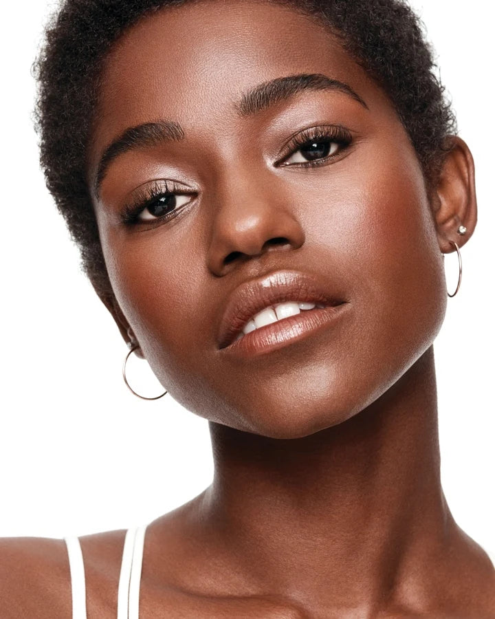 a person with short hair and earrings