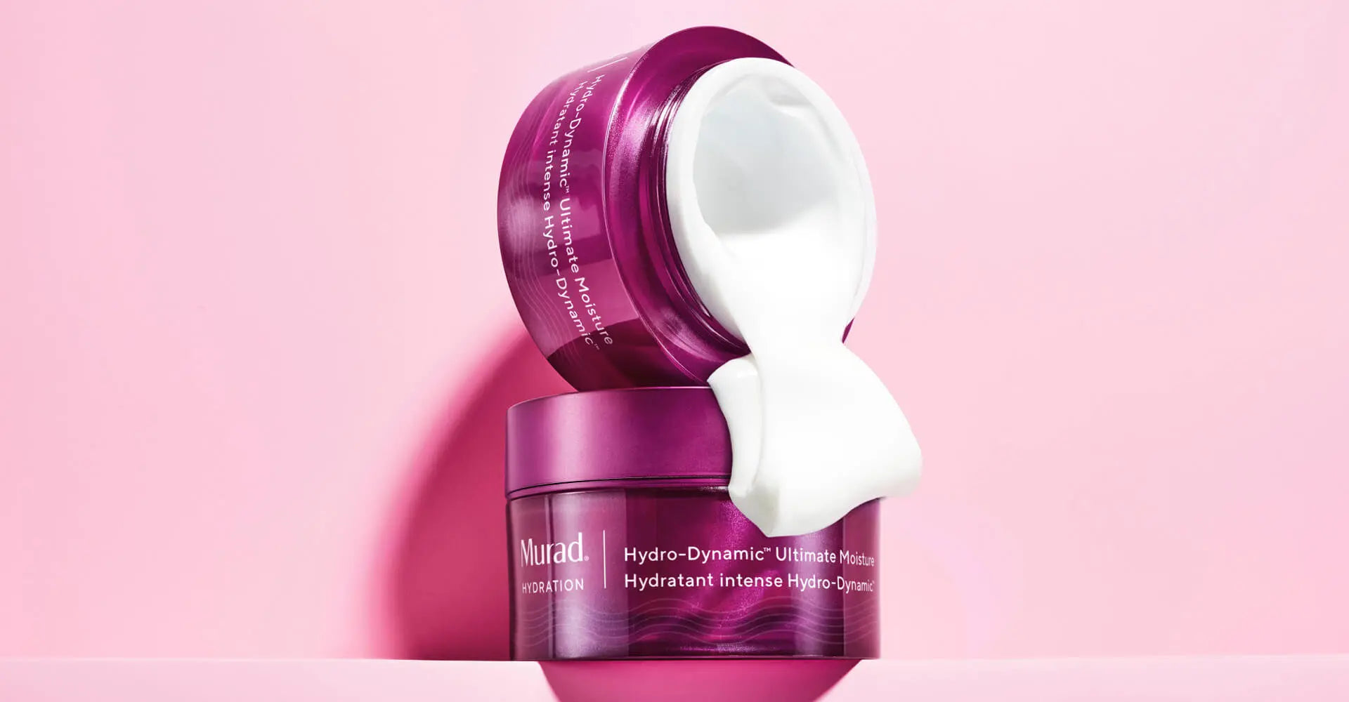 A jar of Hydro-Dynamic Ultimate Moisture coming out onto another jar