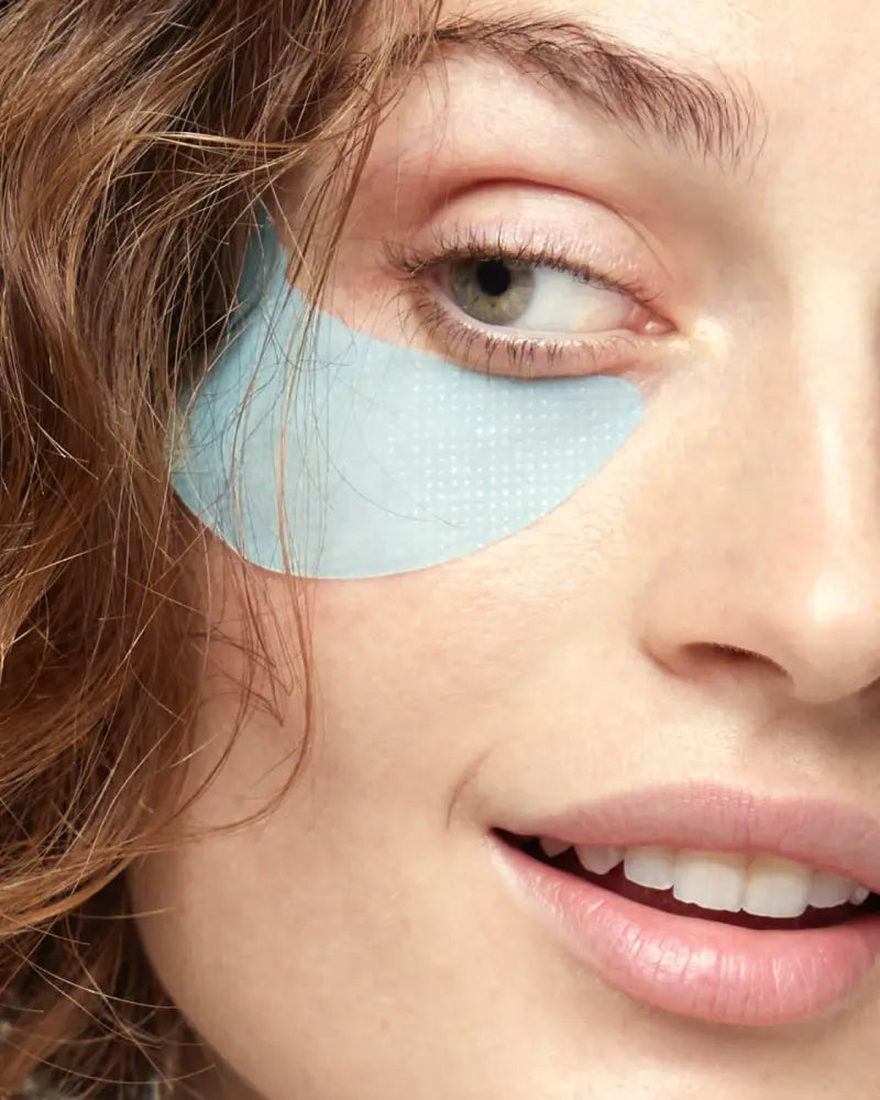 A person with a Retinol Youth Renewal Eye Mask on