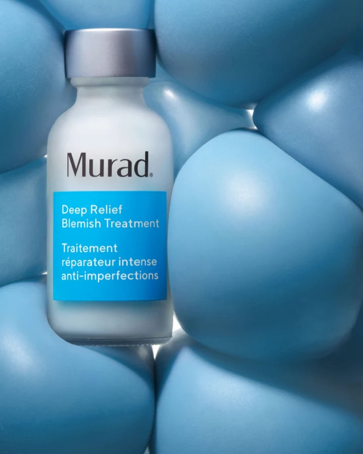 A bottle of Deep Relief Blemish Treatment amung blue balls