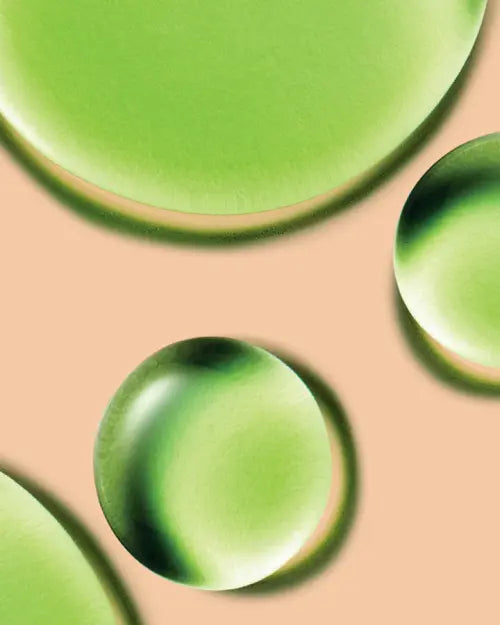 a close-up of green liquid drops
