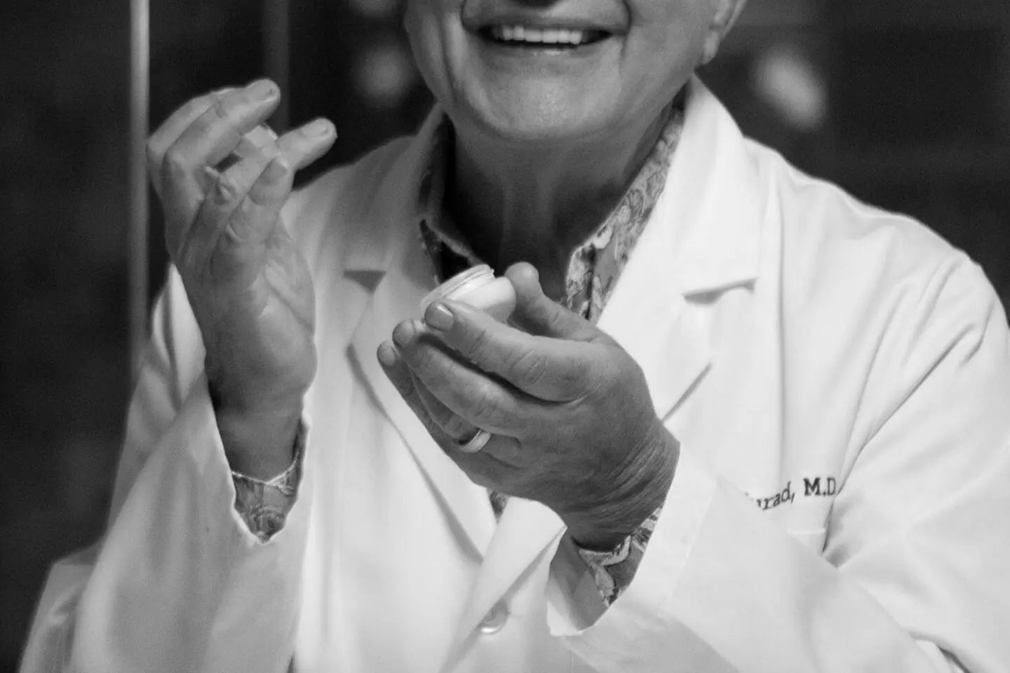 Dr. Murad holding an orginial Murad cream