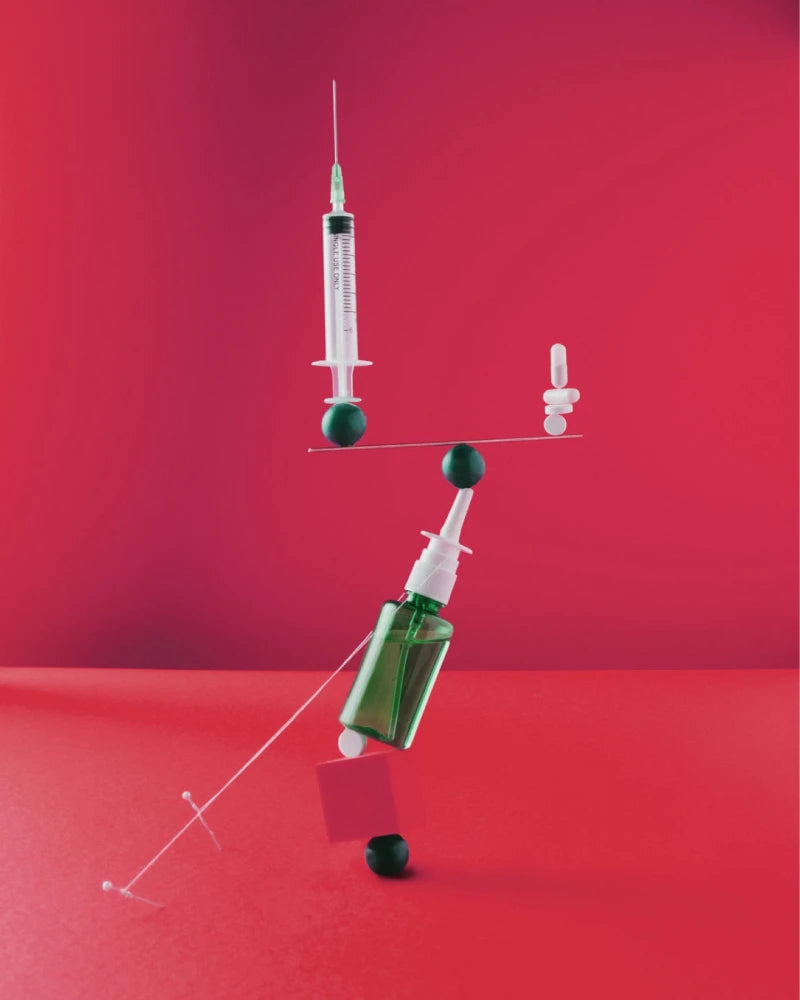 A syringe and a bottle balancing