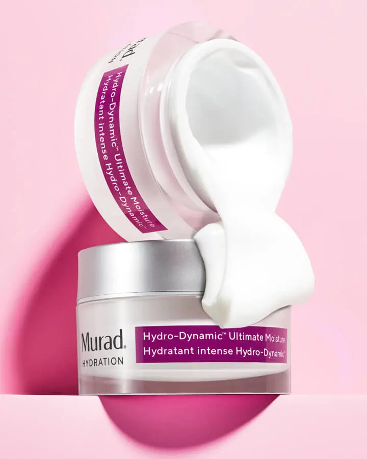 A jar of Hydro-Dynamic Ultimate Moisture pouring over another