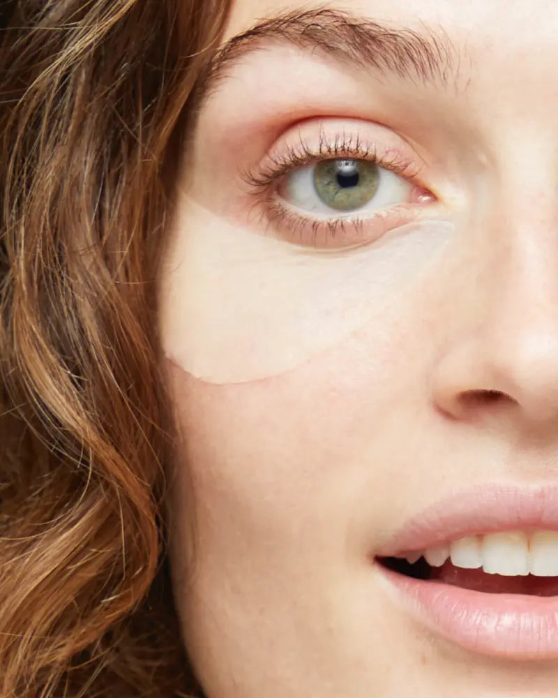 A close up of a person's face with a retinol eye mask on