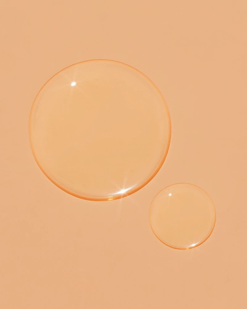 A close up of clear liquid on an orange background