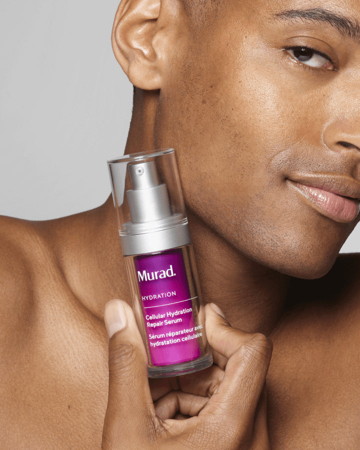 A person holiding a bottle of Cellular Hydration Repair Serum