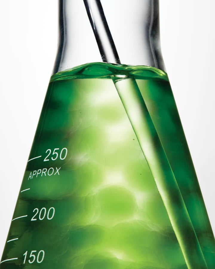 a beaker with green liquid in it