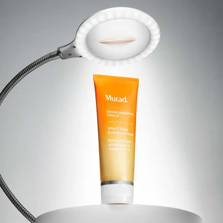 A light on a table with a tube of Vita-C Triple Exfoliating Facial