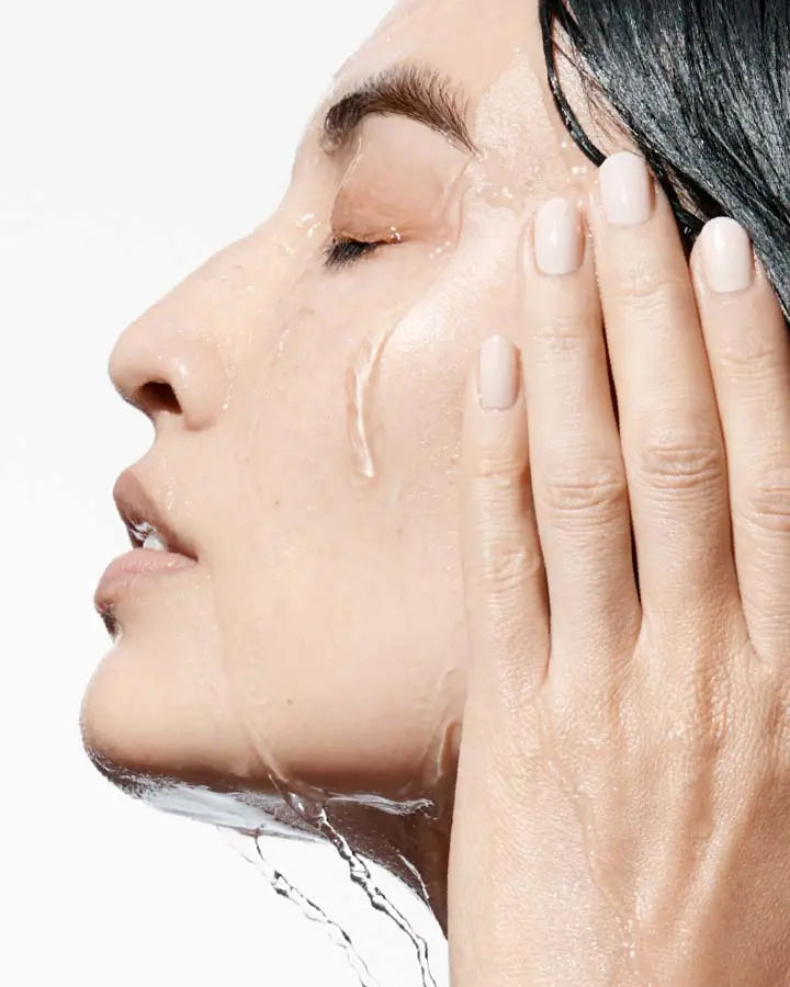 A person washing her face