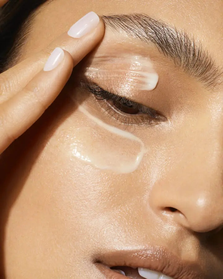 a person applying a gel on her eye